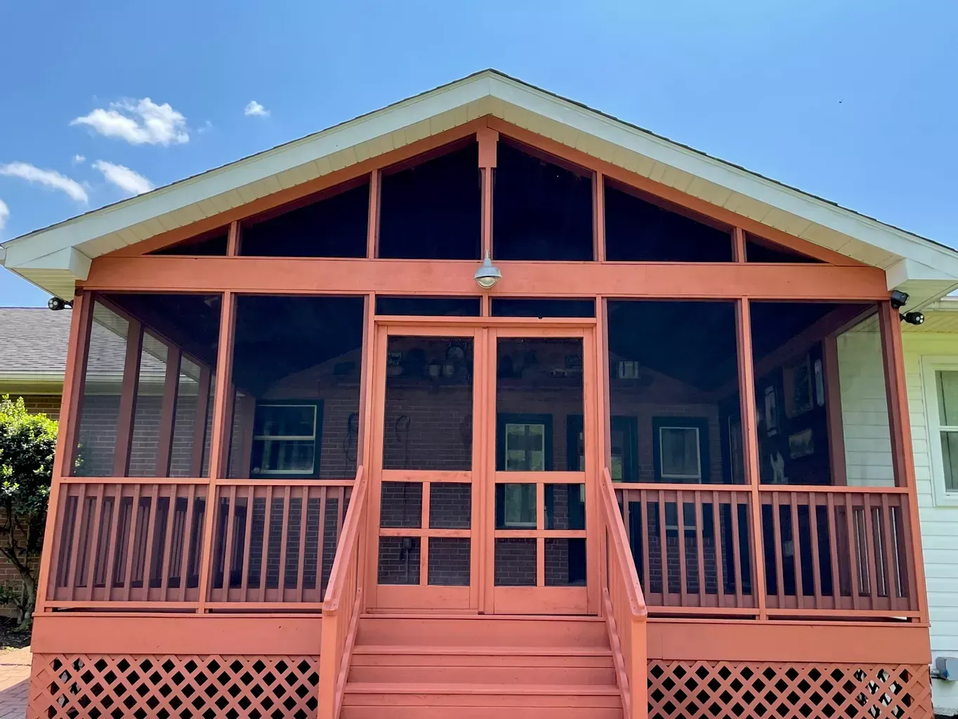 A house with a screened in porch and stairs