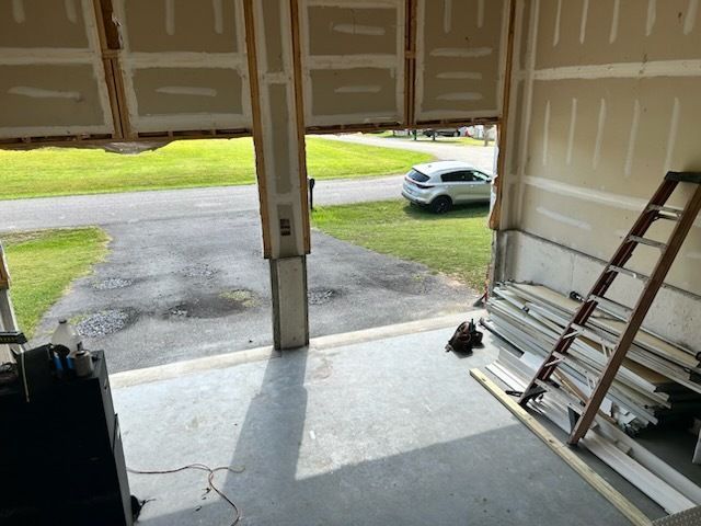 A ladder is sitting in front of a door that is being remodeled.