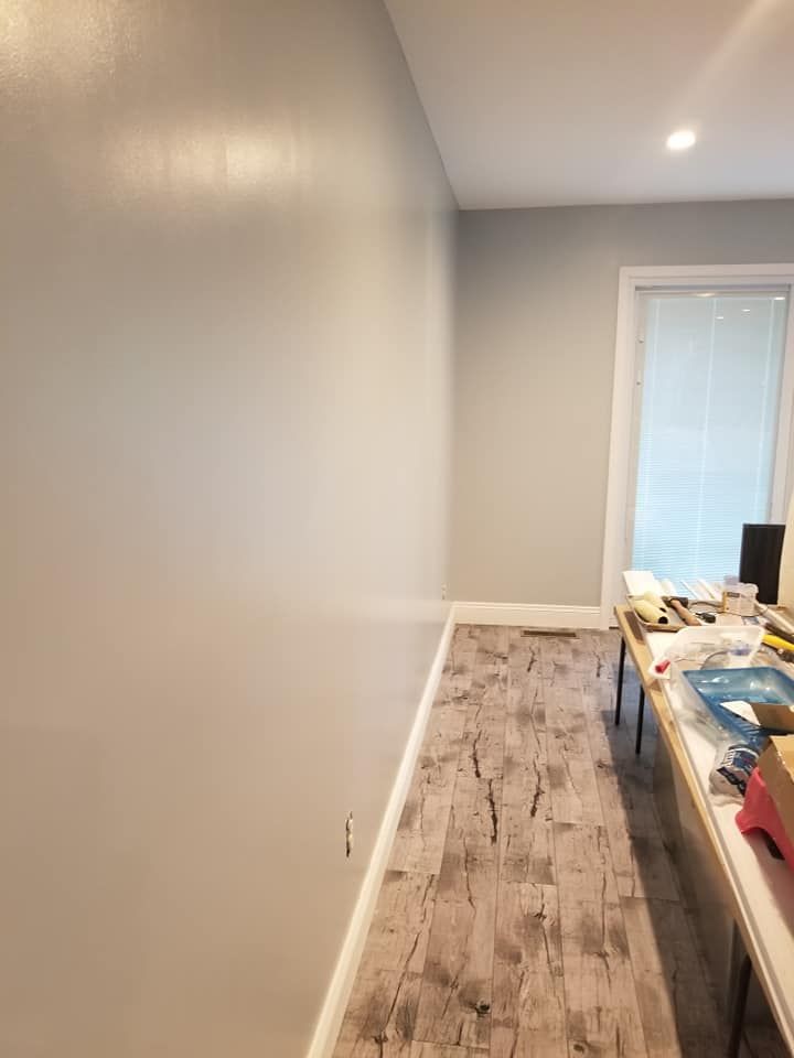 A room with white walls and a wooden floor.