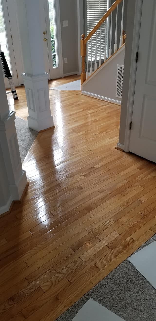 A living room with hardwood floors and a staircase.