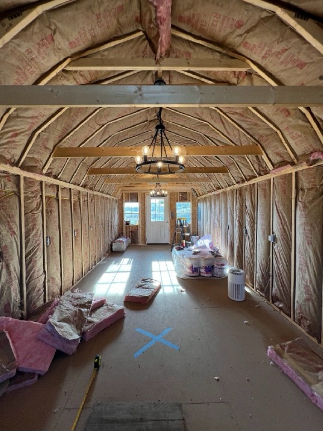 A large room with a chandelier hanging from the ceiling.