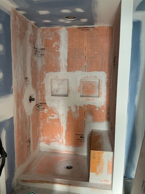 A house with a porch and stairs is being painted.