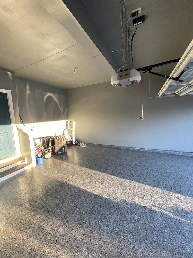 A garage with a garage door opener hanging from the ceiling.