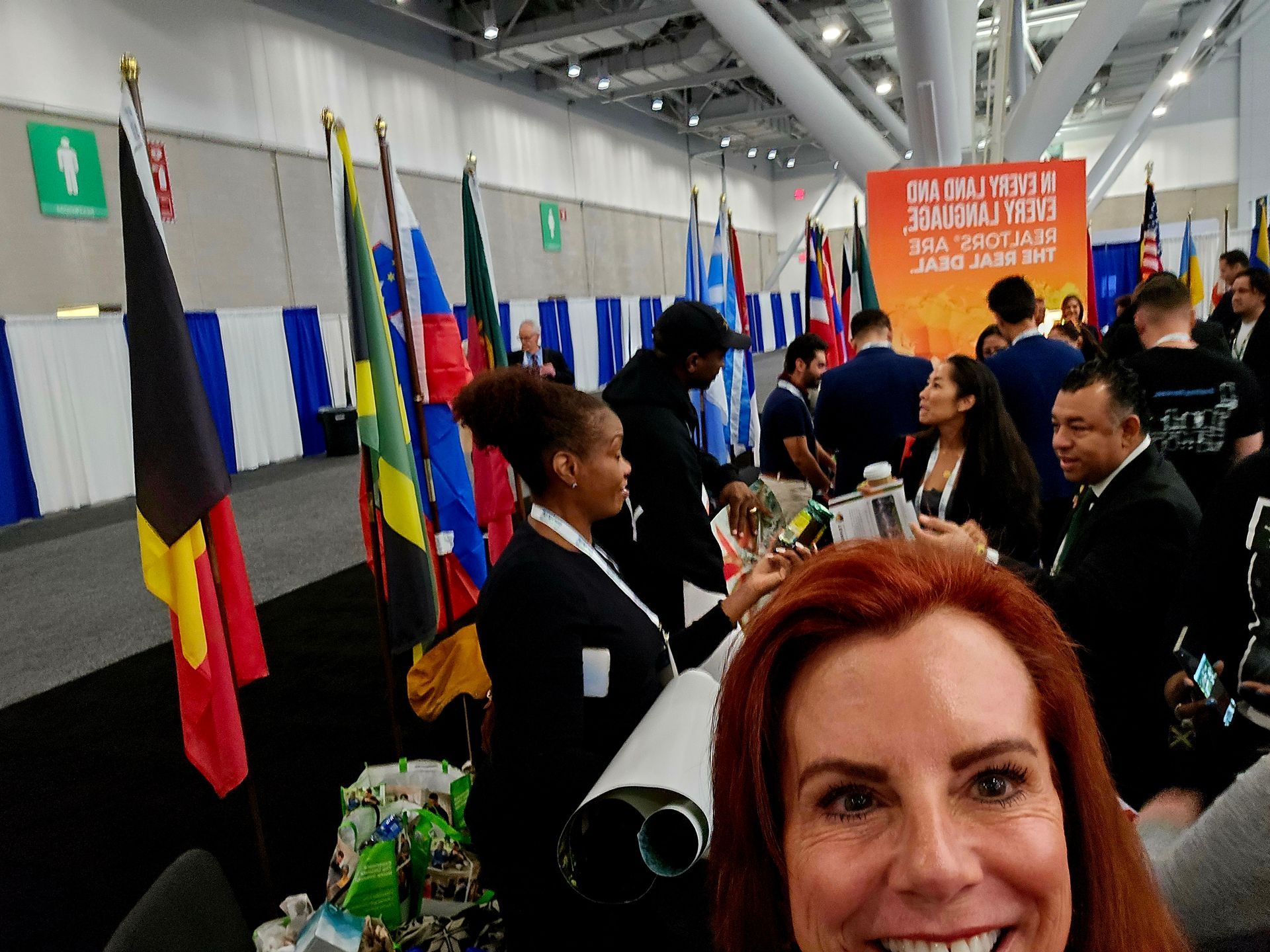 A woman taking a selfie in front of a sign that says immigration