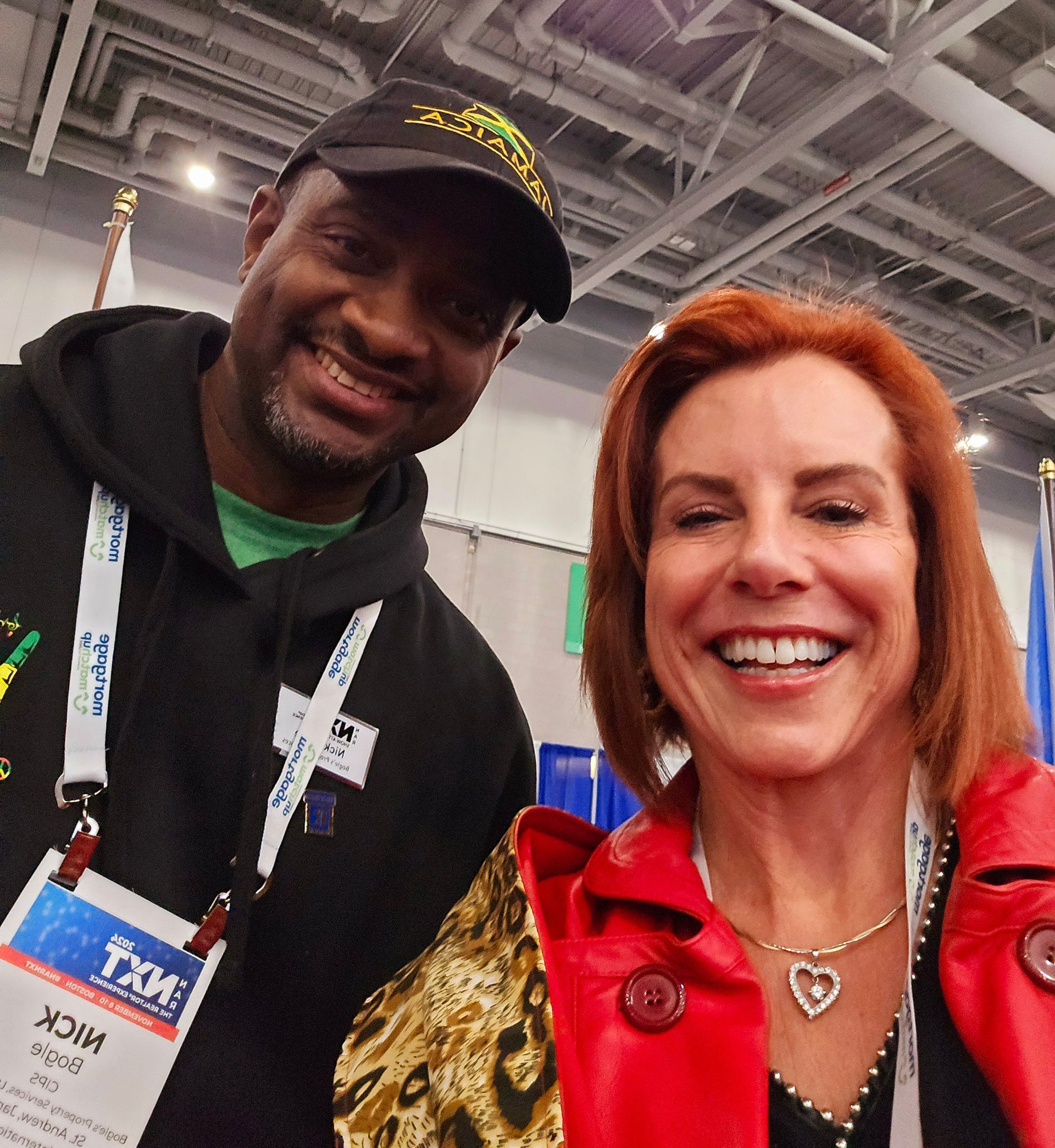 A man and a woman are posing for a picture and the man has a tag that says tkm