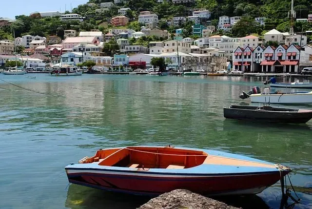 A red and blue boat is docked in a harbor