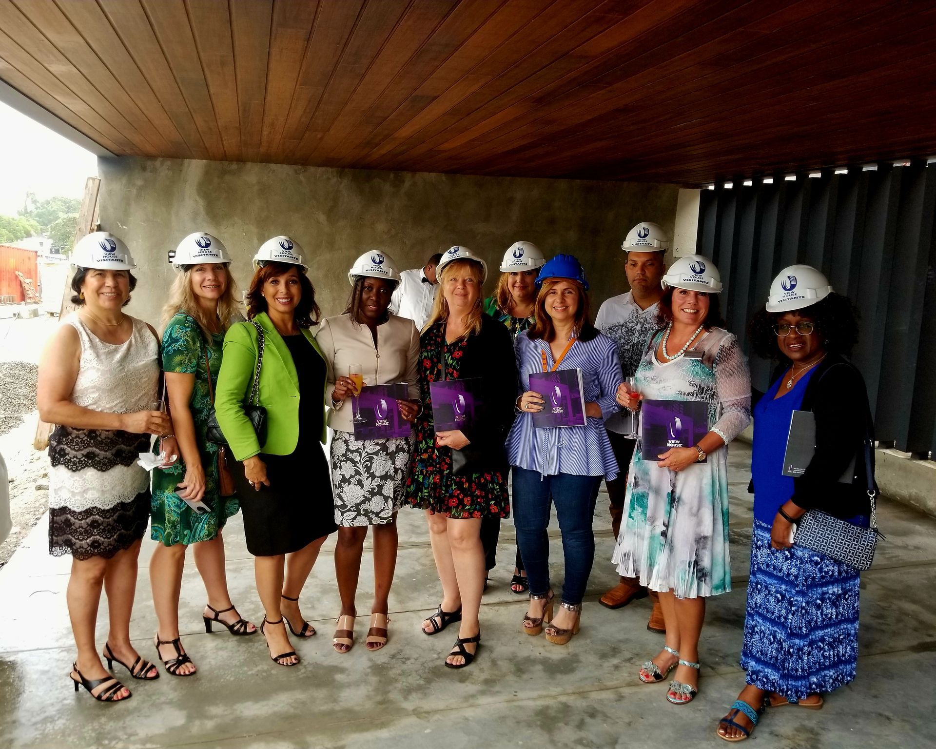 A group of women wearing hard hats are posing for a picture