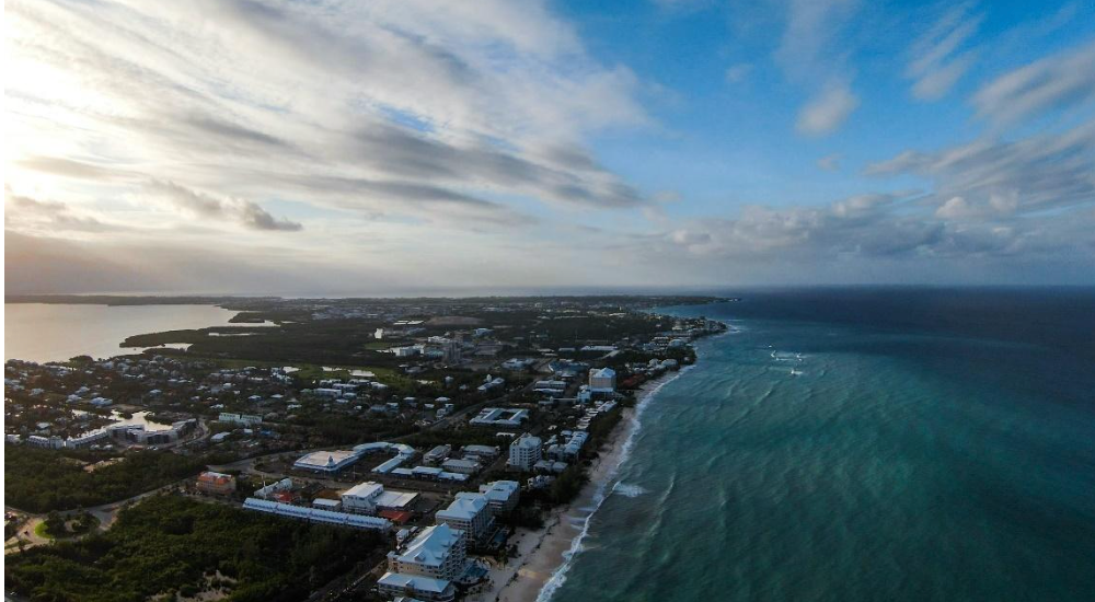 An aerial view of a city next to the ocean.