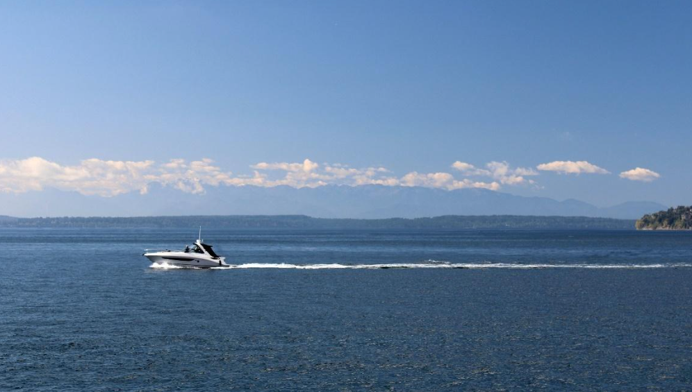 A boat is floating on top of a large body of water.