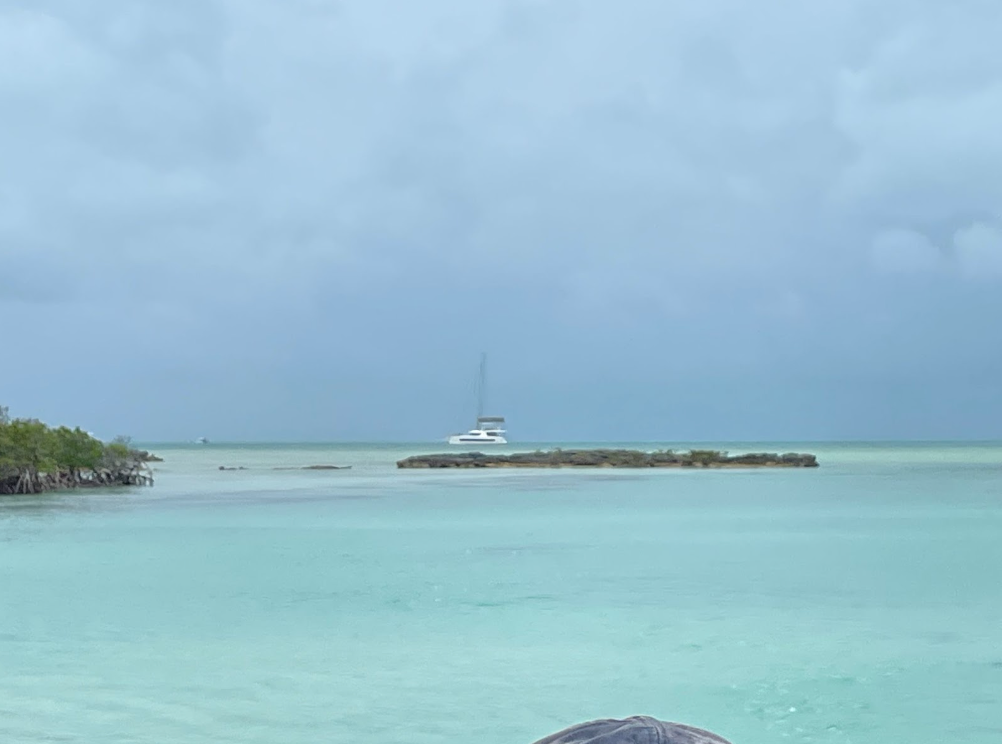 A boat is floating on top of a large body of water.