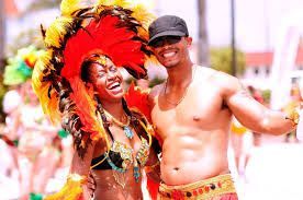 A man and a woman are posing for a picture at a carnival.