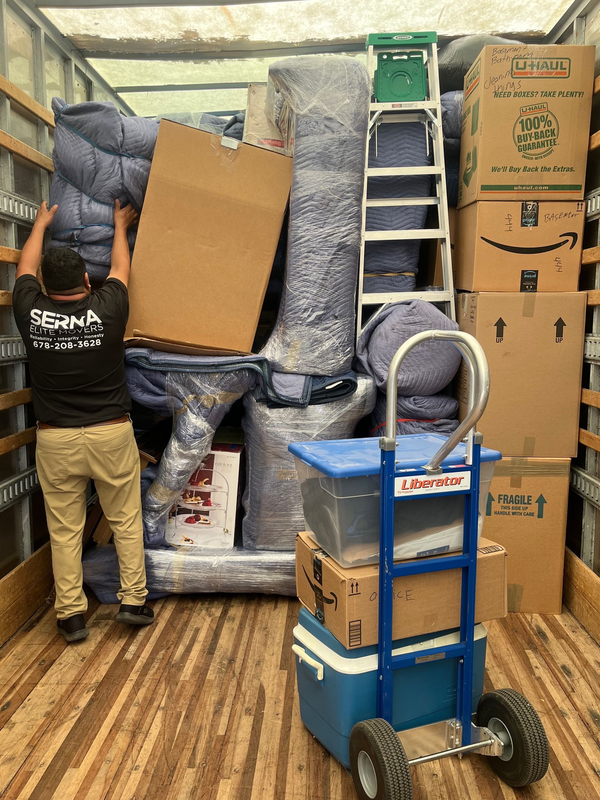 A man is loading boxes into a moving truck.