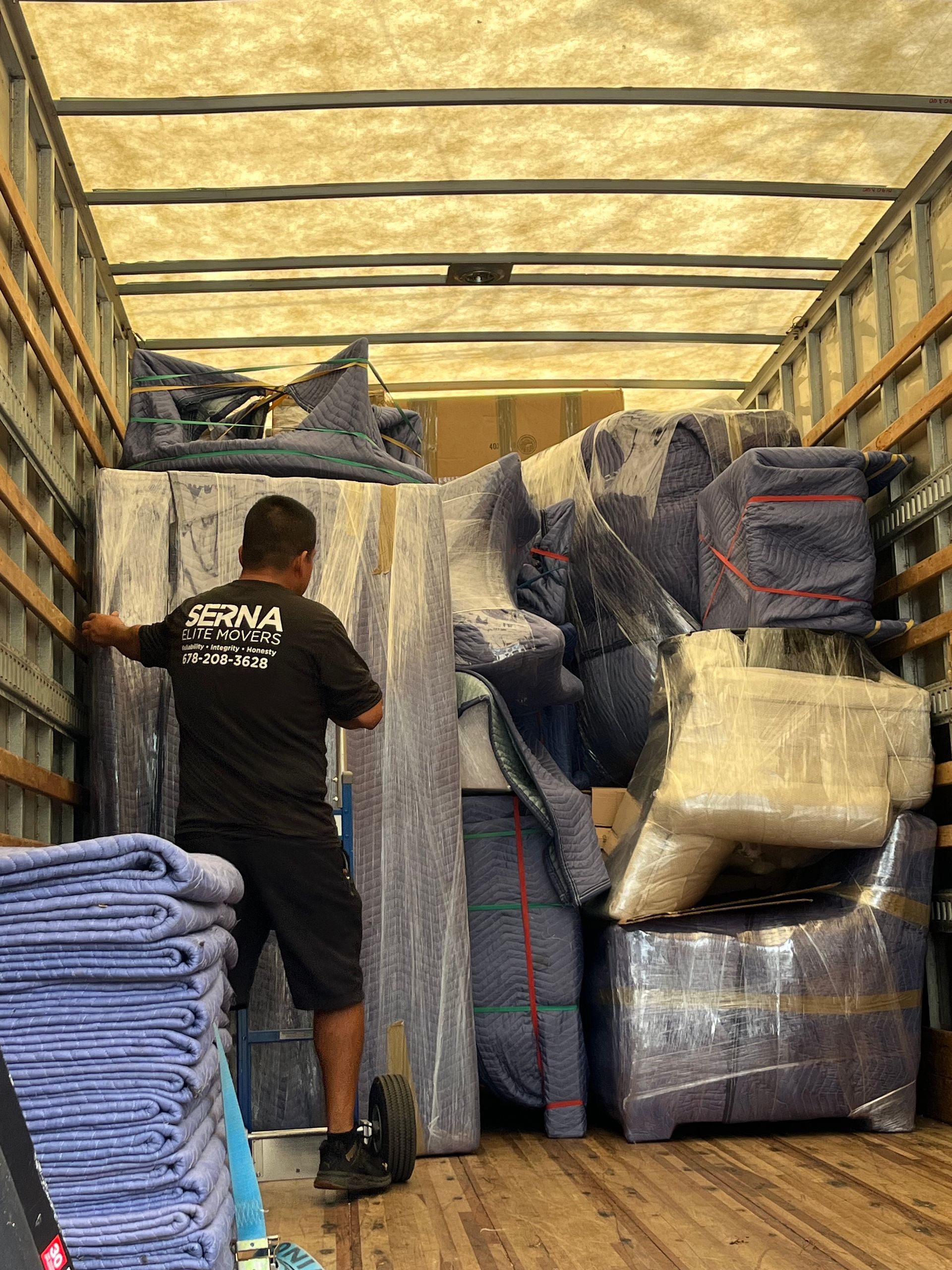 A man is loading furniture into a moving truck.