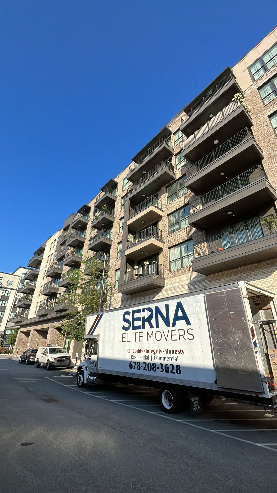 A serna elite movers truck is parked on the side of the road