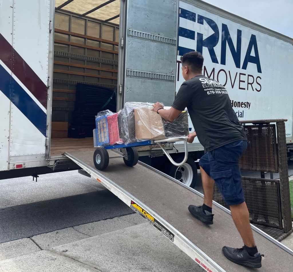 A man is loading boxes onto a moving truck.