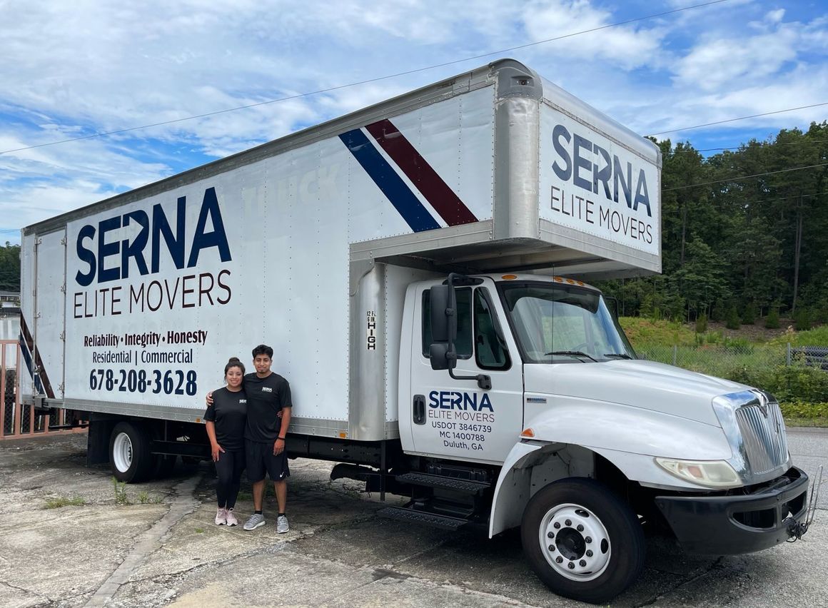 A man and a woman are standing in front of a moving truck.