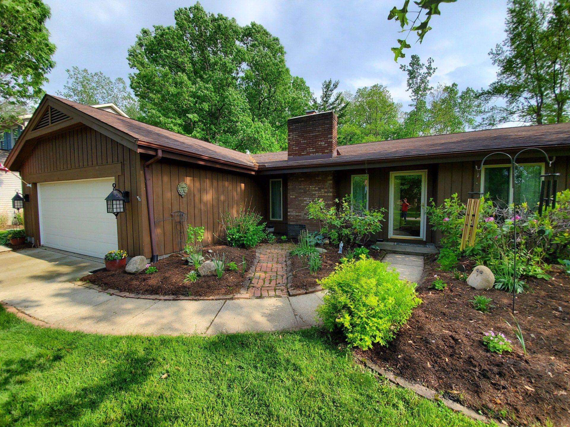 A house with a garage and a walkway in front of it