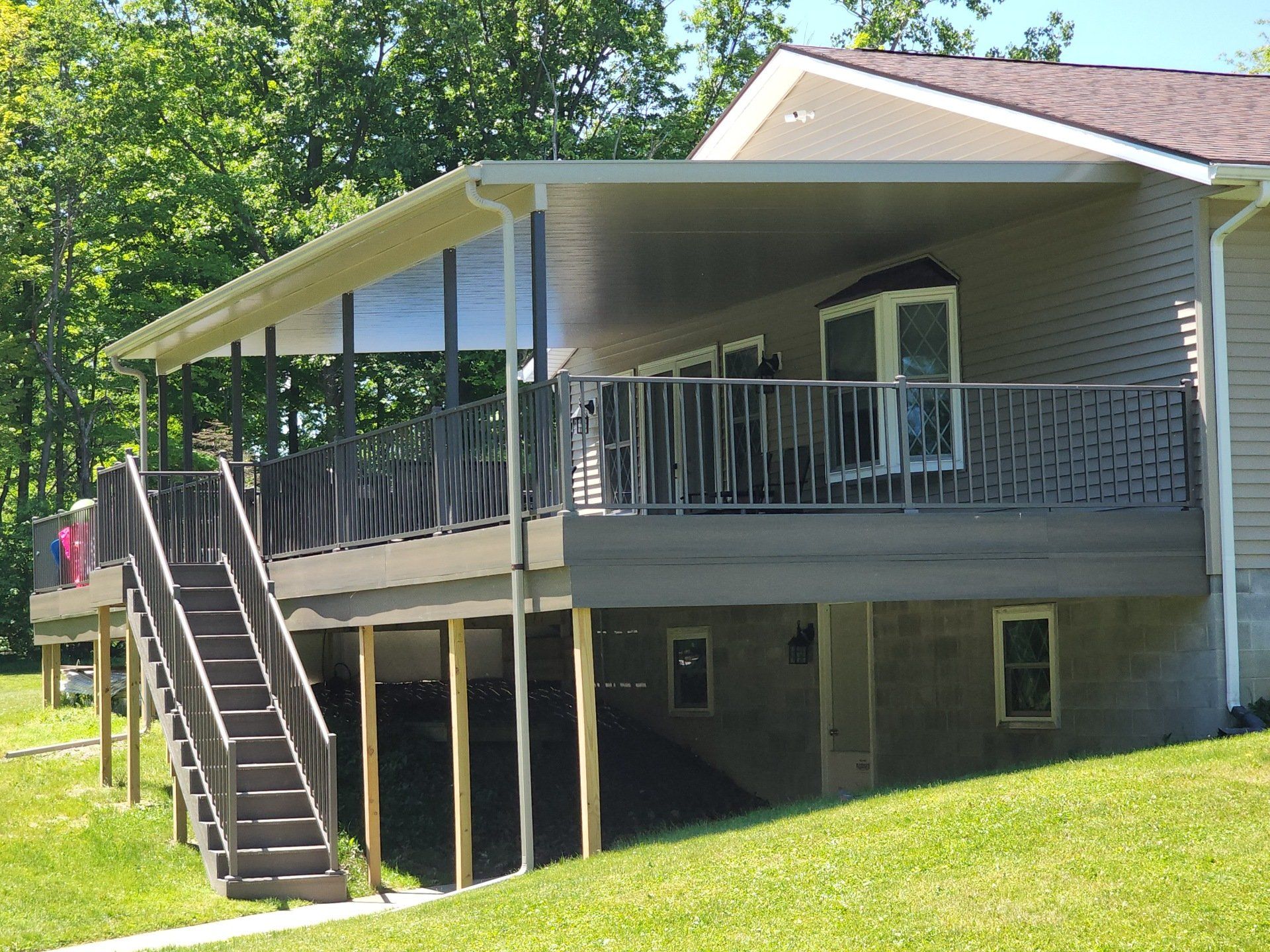 A house with a large deck and stairs leading up to it