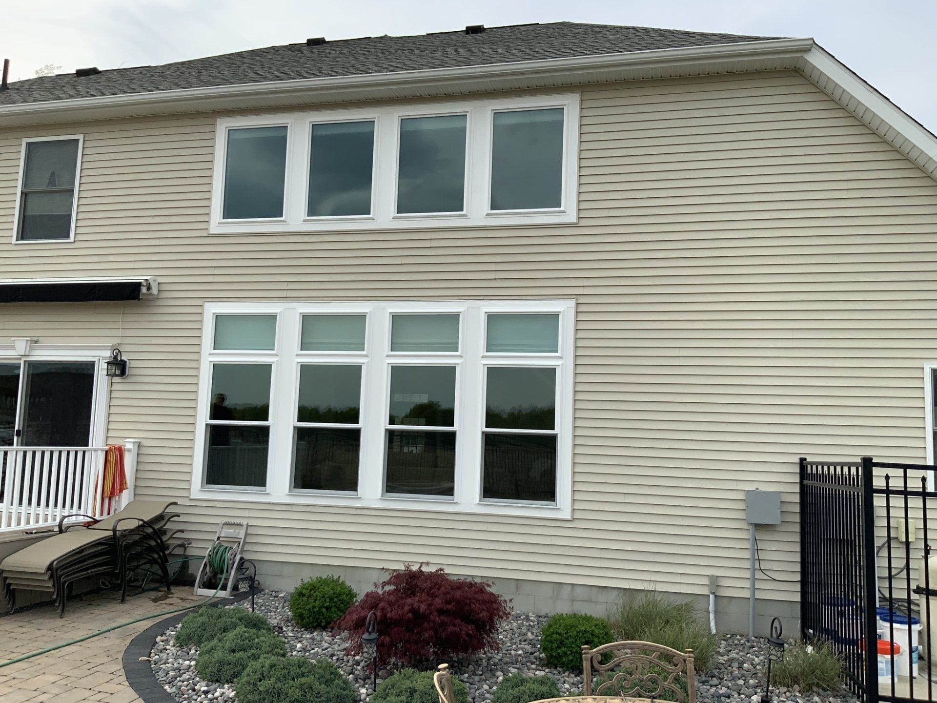 A large house with a lot of windows and a fence in front of it.