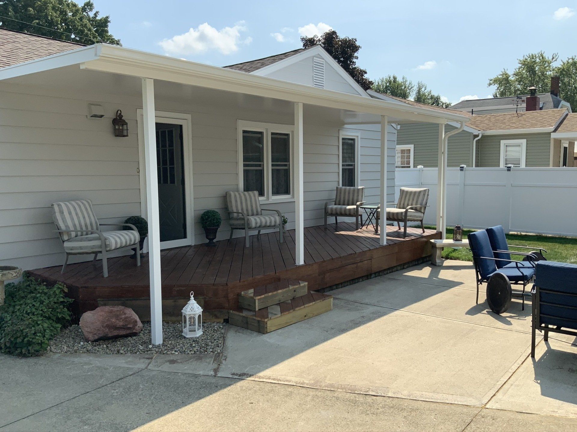 A house with a porch and chairs in front of it