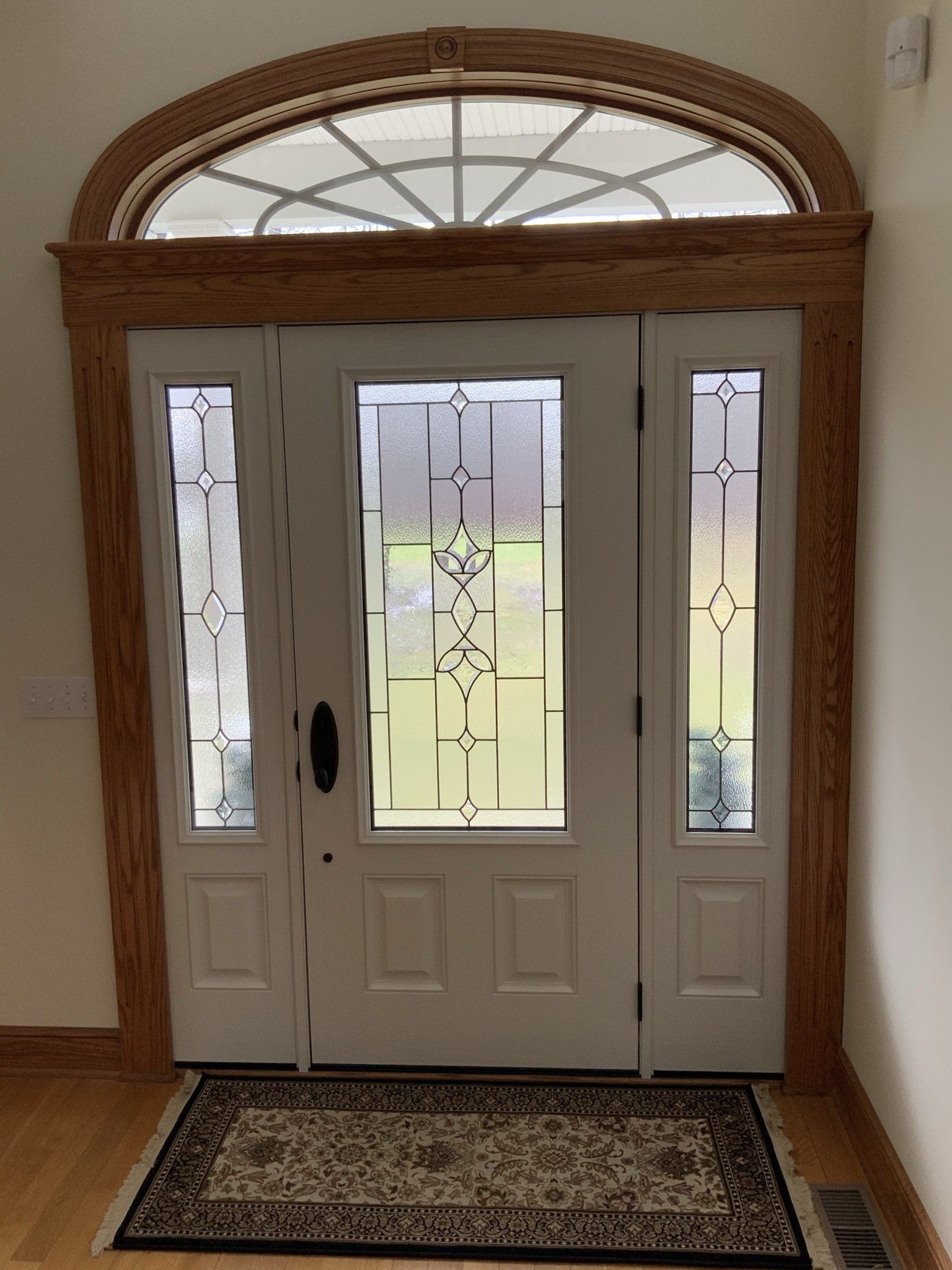 A white door with a rug in front of it