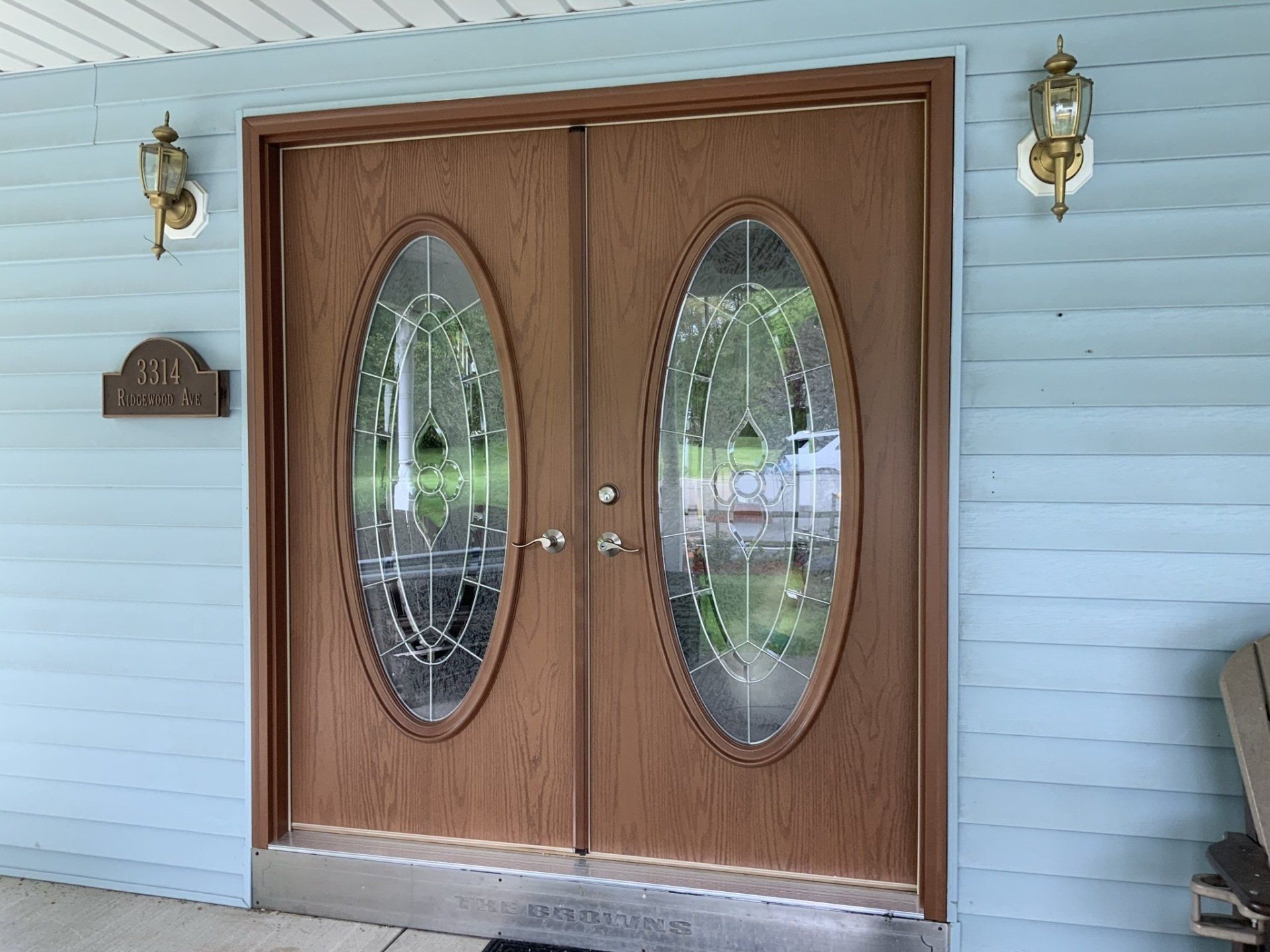 The front door of a house has two oval windows