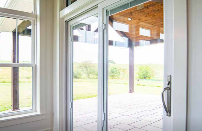 A room with a sliding glass door leading to a patio.