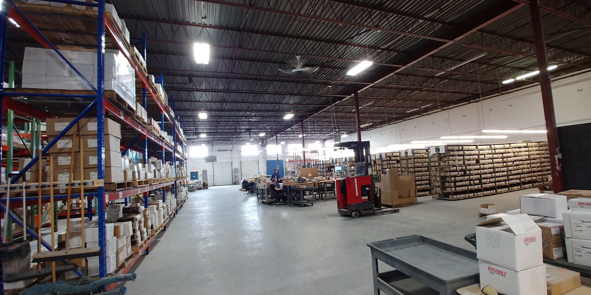 Un grand entrepôt rempli de nombreuses étagères et cartons.