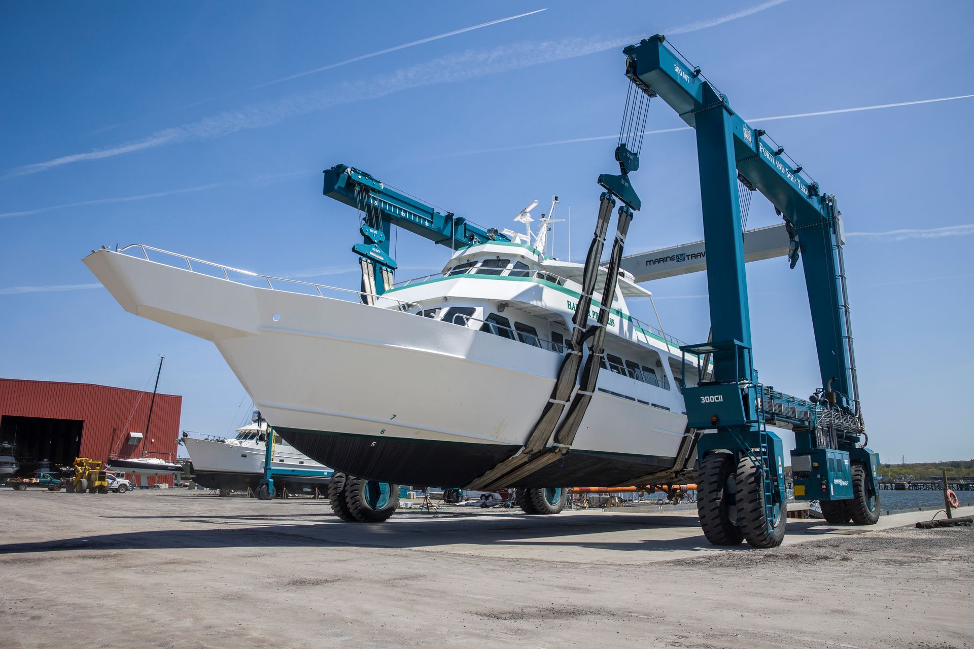 A boat is being lifted by a large crane