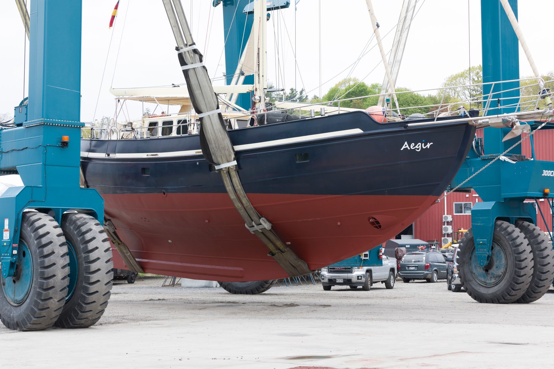 A large boat is sitting in front of a red building