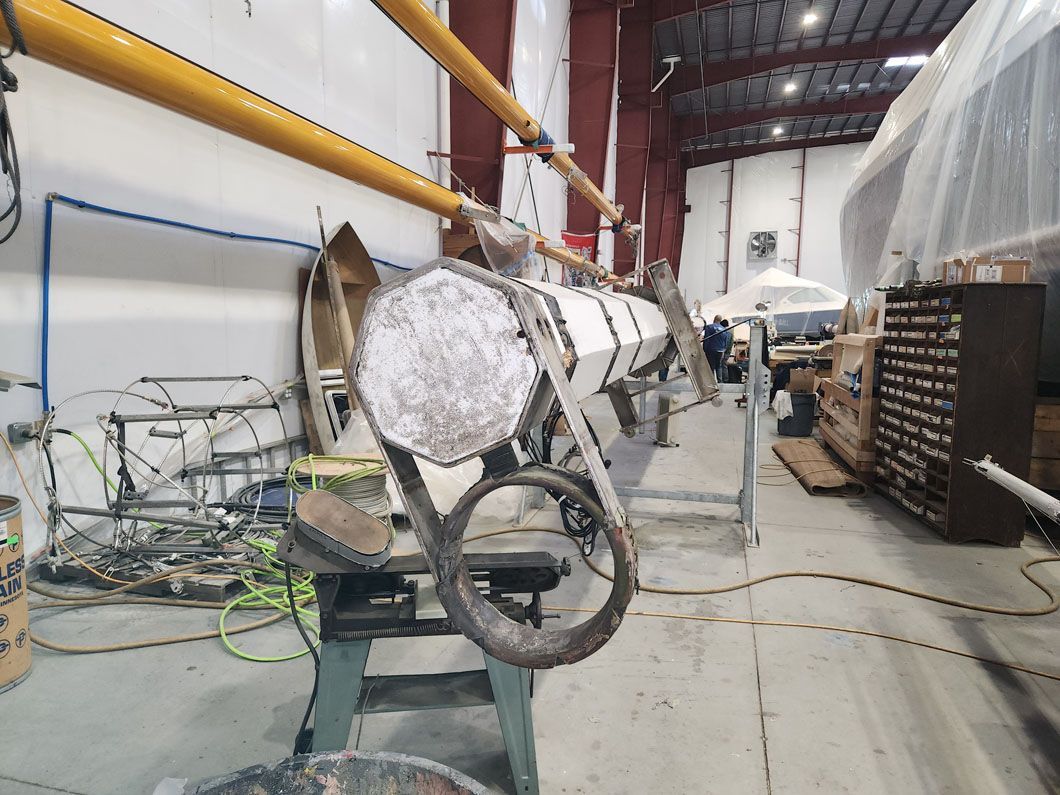 A large piece of metal is sitting on a table in a factory.