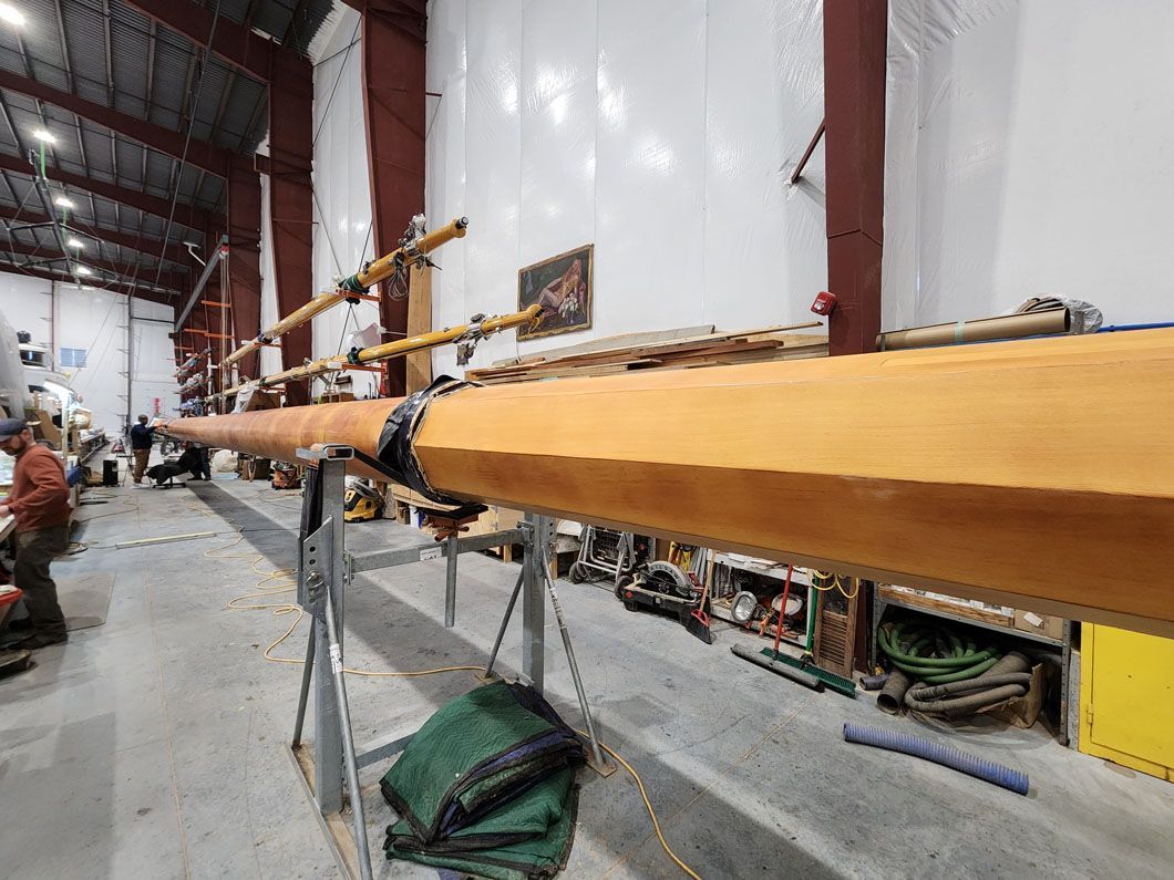 A large piece of wood is sitting on a metal stand in a warehouse.