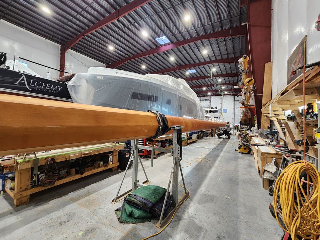 A boat is being built in a large warehouse.