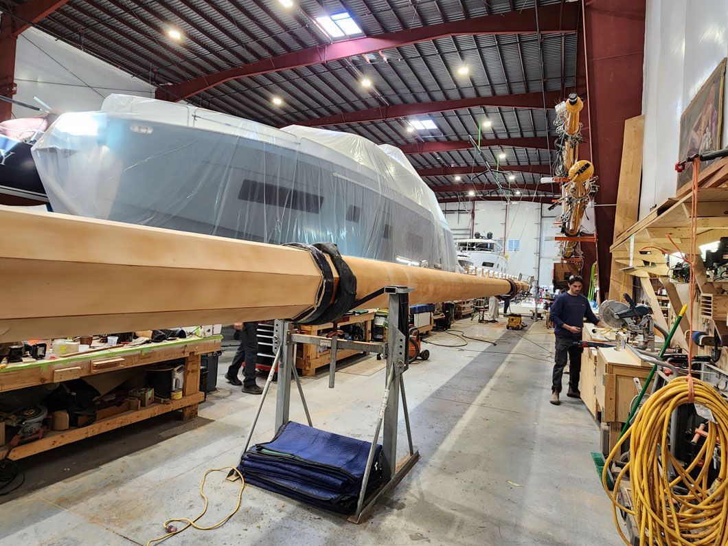A large boat is being built in a warehouse.