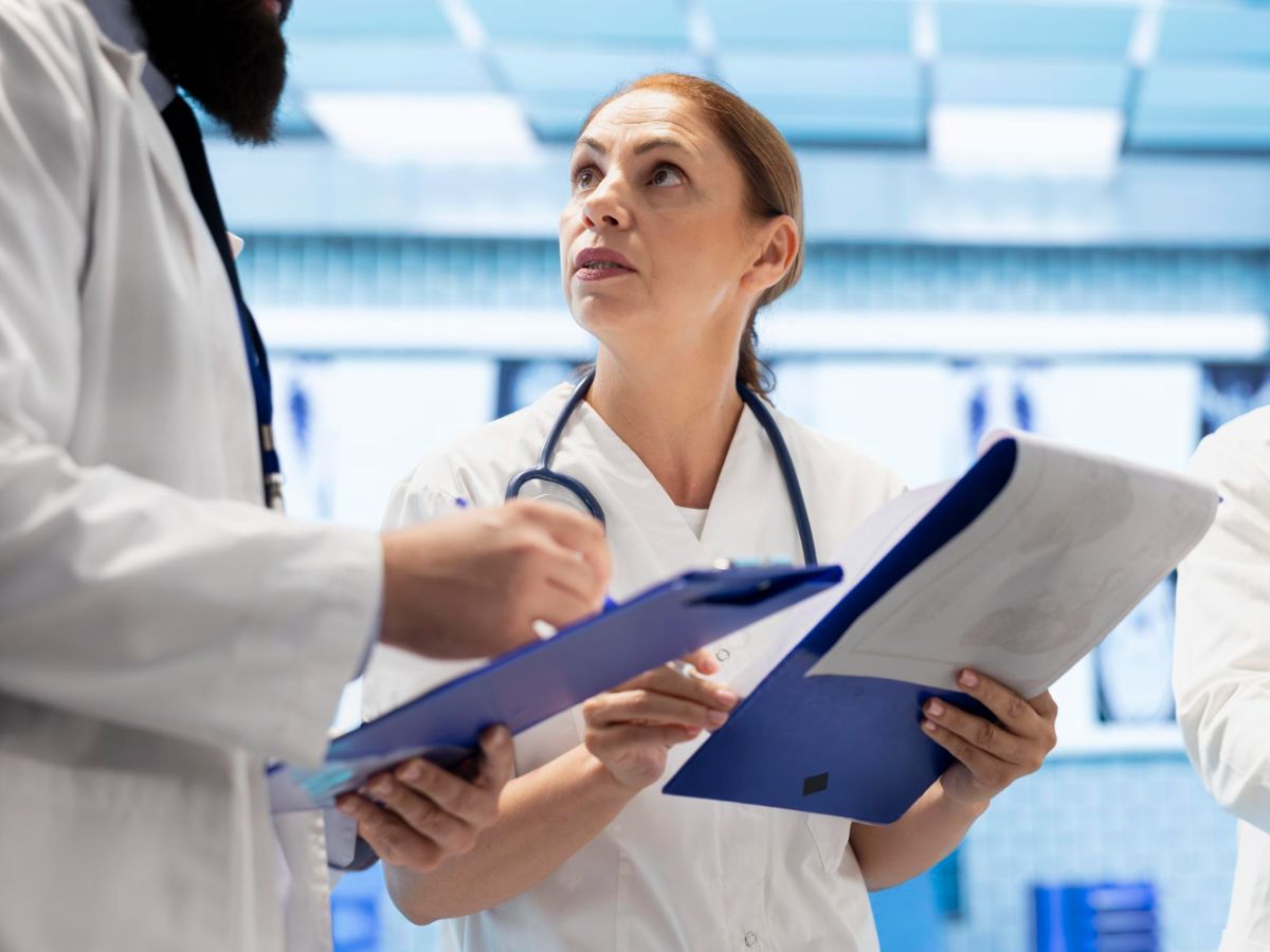 A primary care provider reviews the test results with the specialist to coordinate the patient's treatment plans.