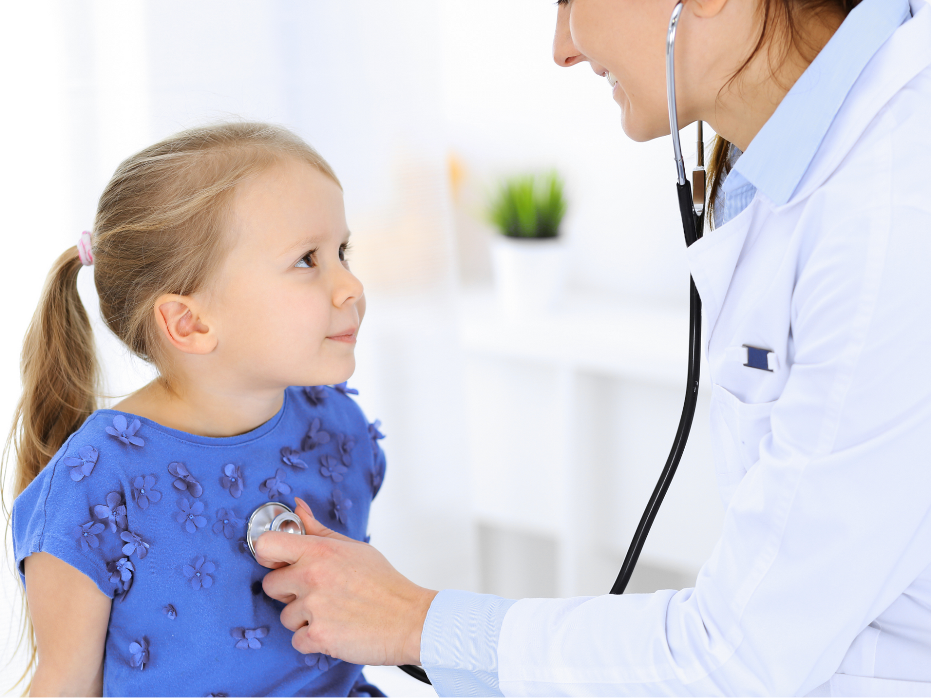 A child smiles at a pediatrician at Allmed of Los Angeles, showing trust, comfort, and positive pediatric care.