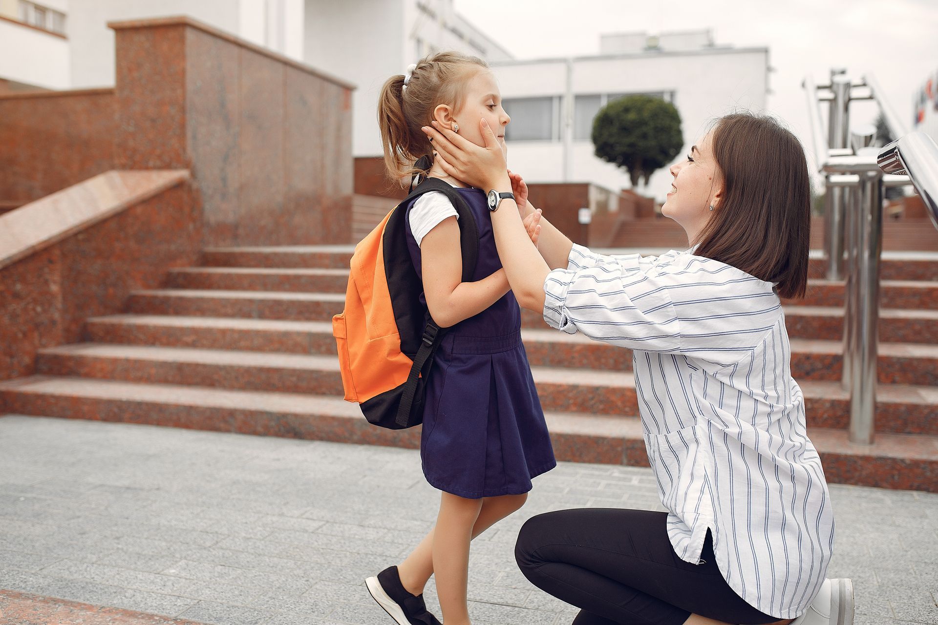 Mother reassures child before school to boost her mental health.