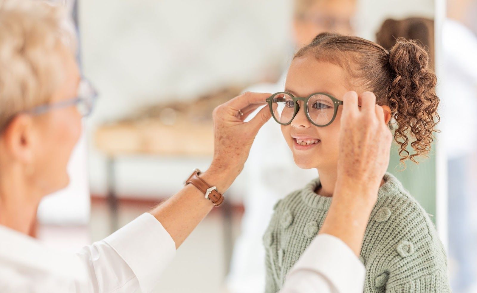 A happy young girl is receiving her new prescriptions for glasses to promote healthy eyes and better vision.