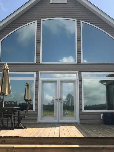 A room with a lot of glass walls and a shelf