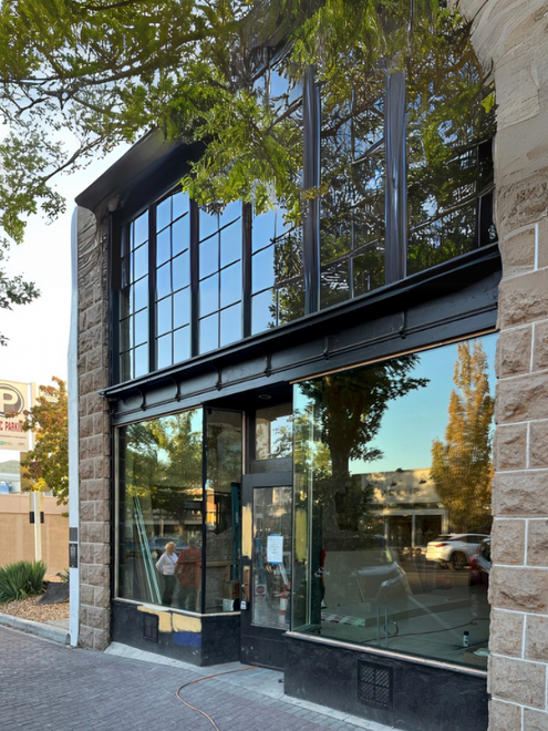 A room with a lot of glass walls and a shelf