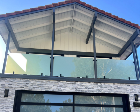 A room with a lot of glass walls and a shelf