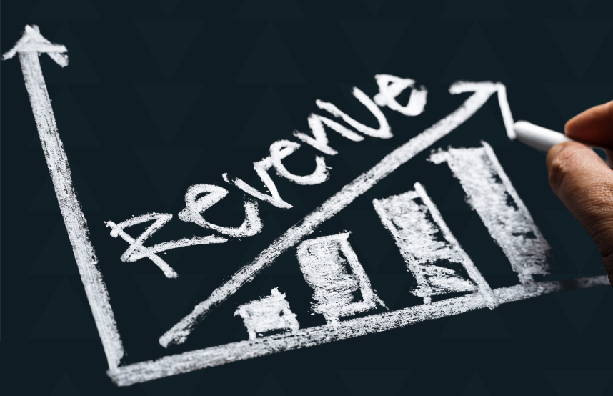 A person is writing the word revenue on a blackboard