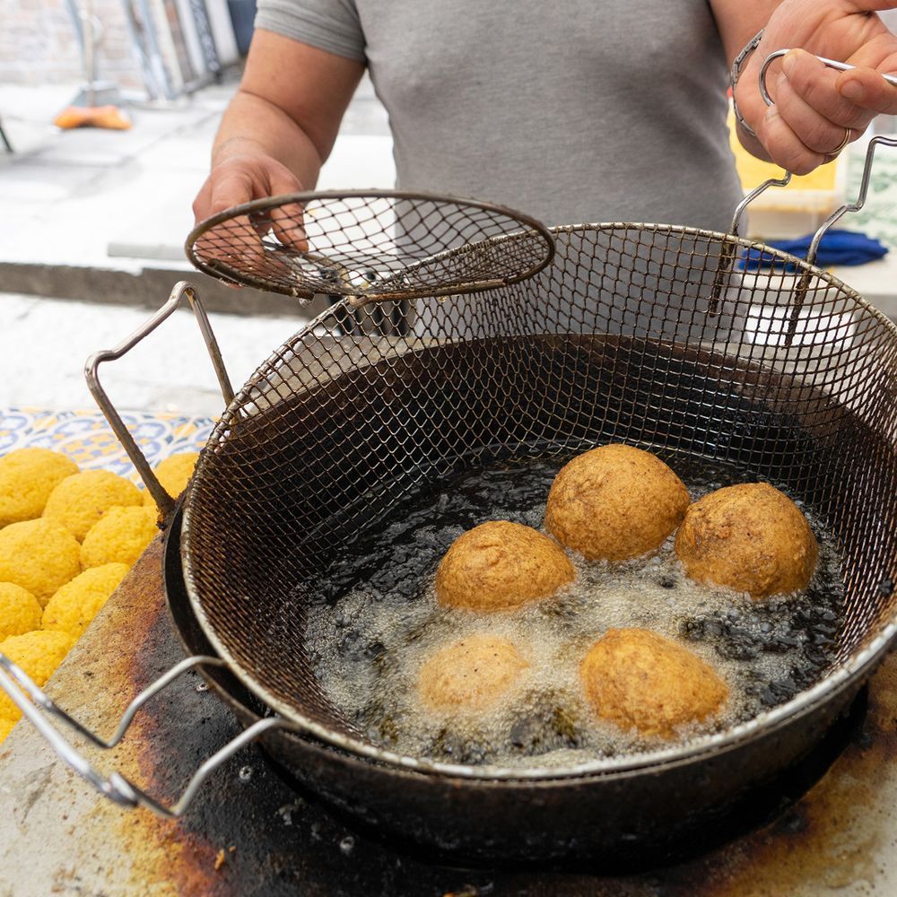 A person is cooking food in a frying pan