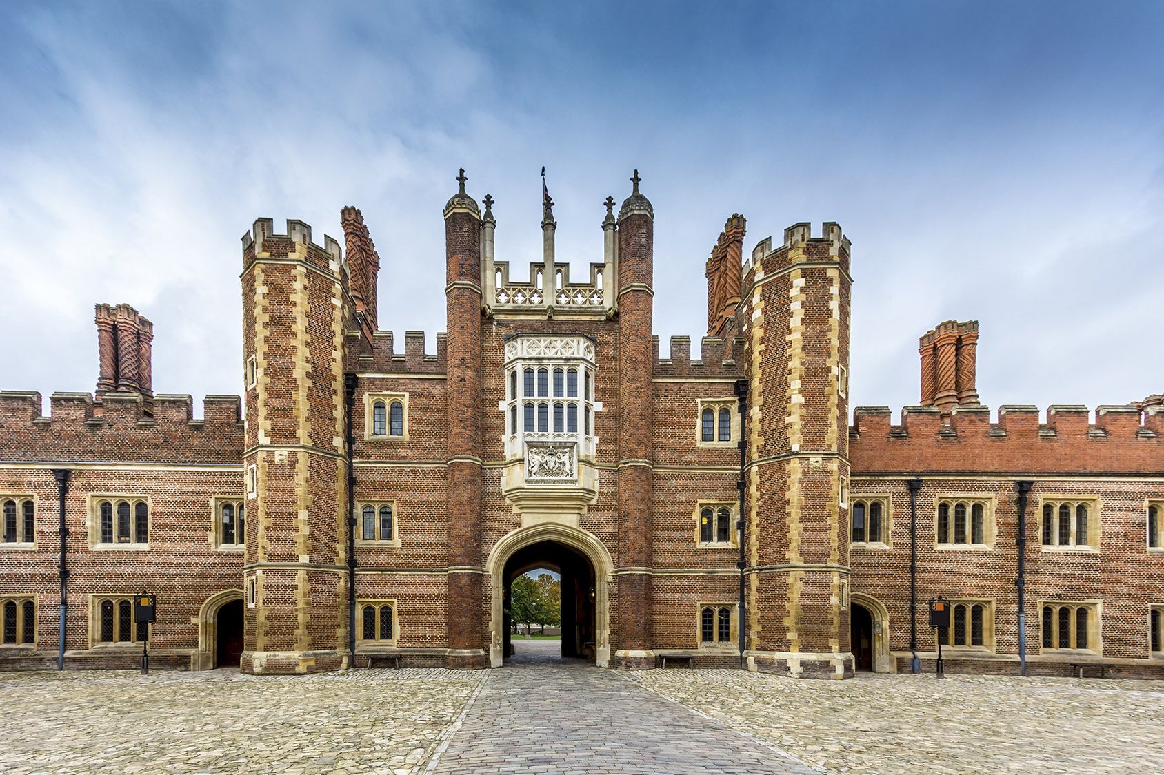 A large brick building with a stone archway in front of it.
