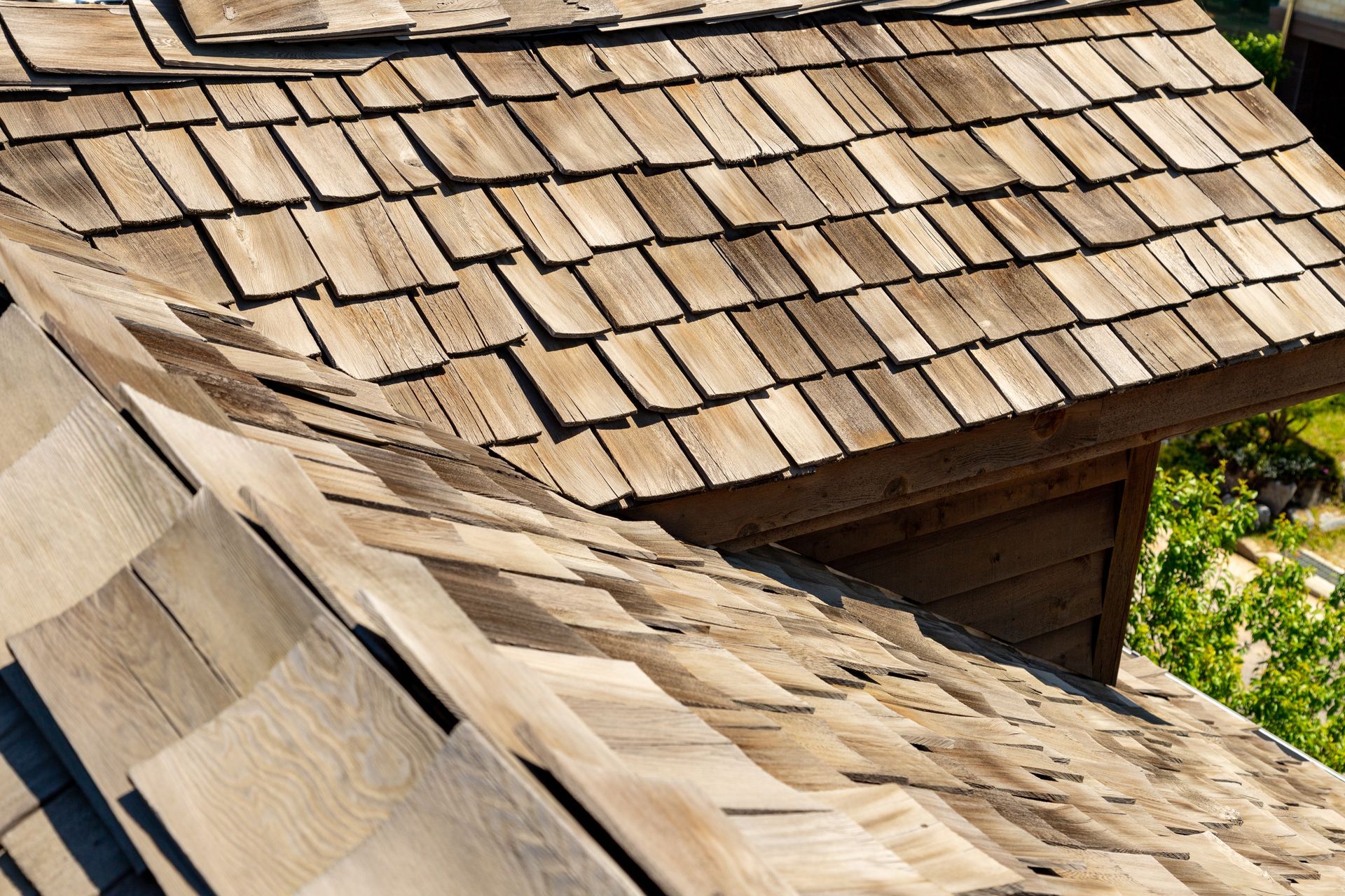 A close up of a wooden roof with shingles on it.