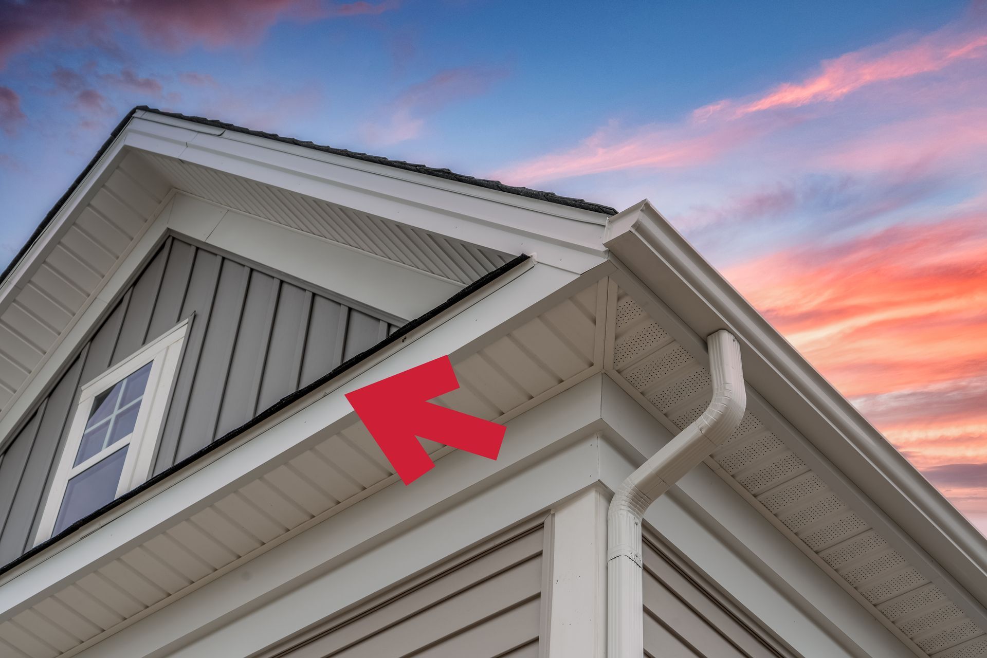 A house with a red arrow pointing to the gutter