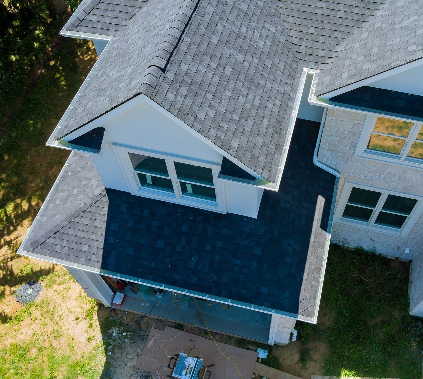 An aerial view of a house with a blue roof