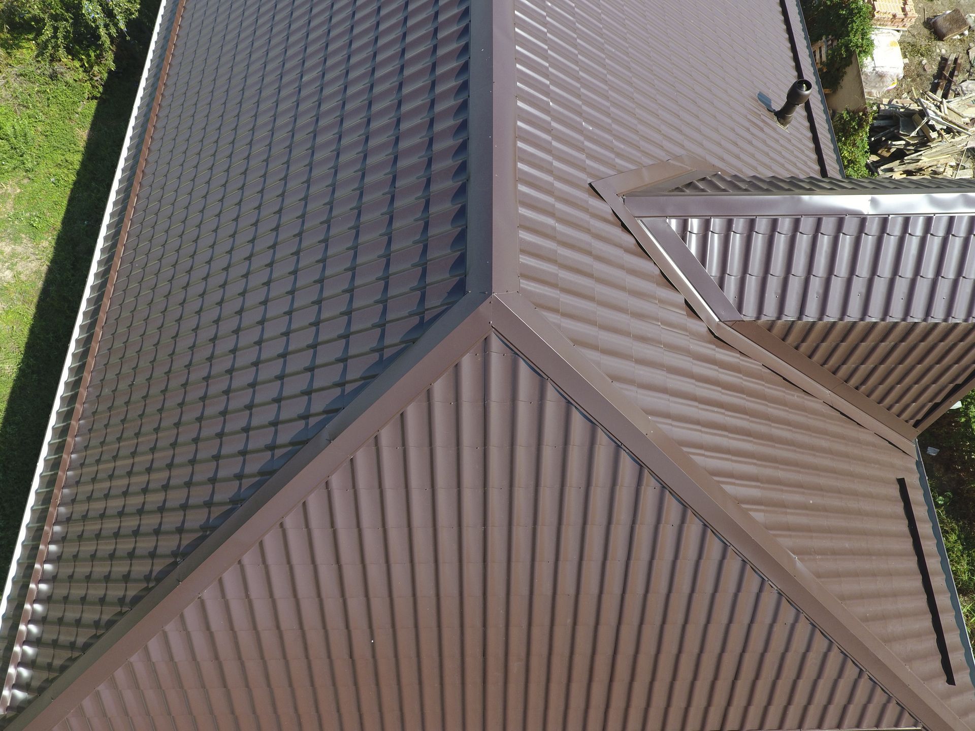 An aerial view of a house with a brown roof