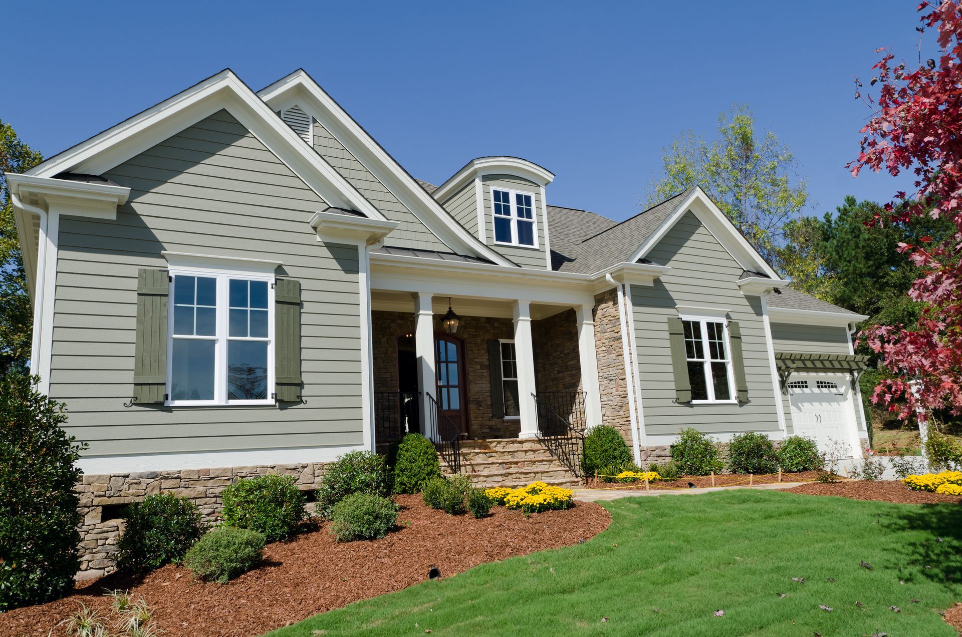 A large house with a lush green lawn in front of it