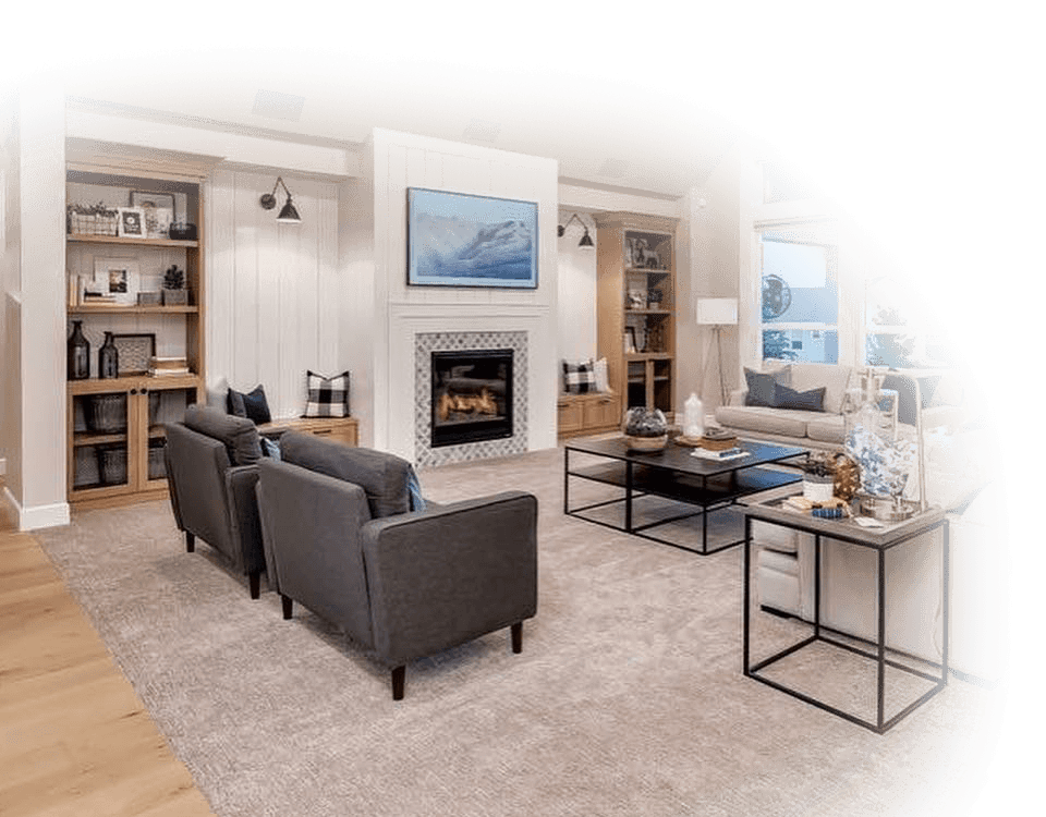 Cozy living room with fireplace, gray sofas, and neutral color scheme.